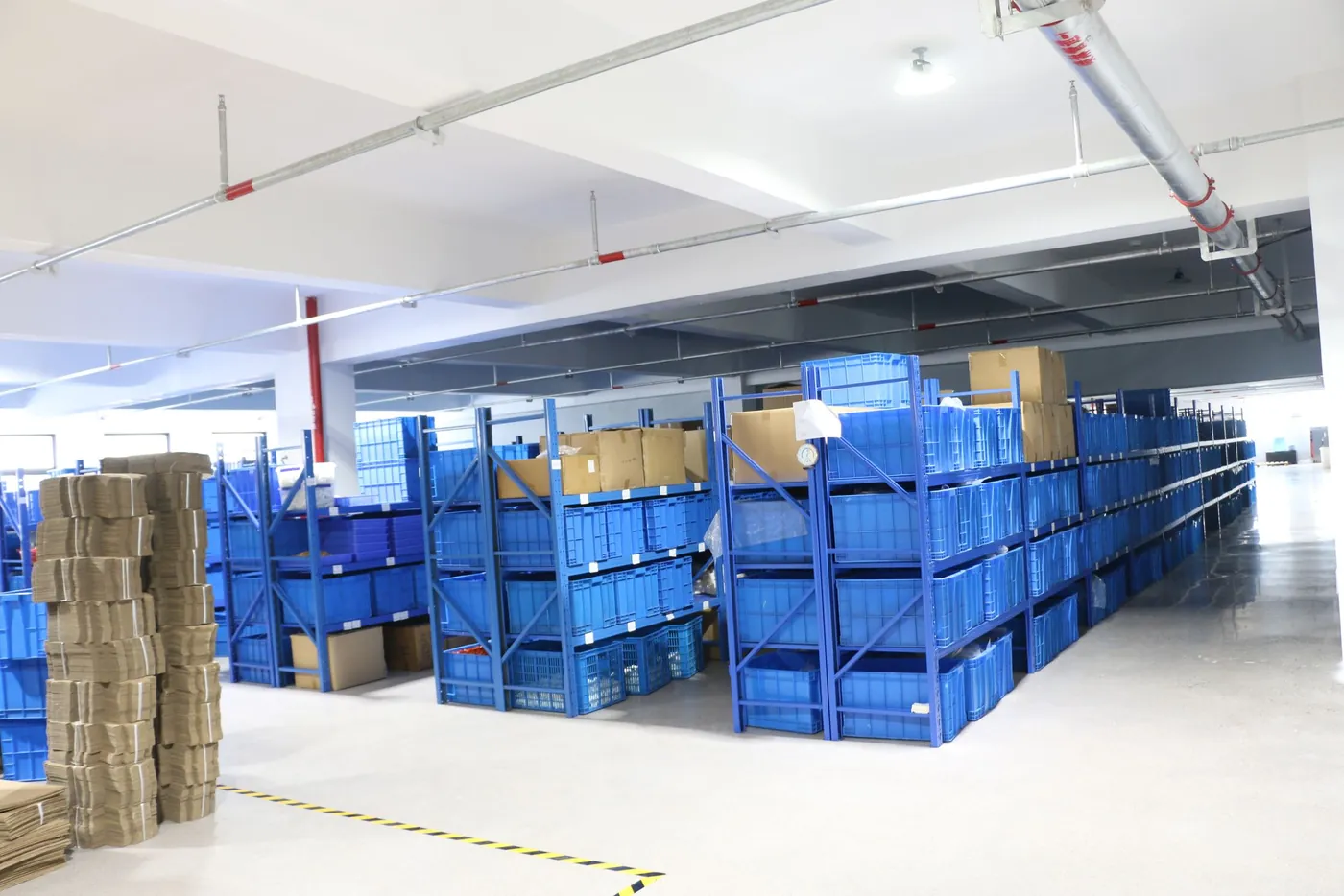 Flat-packed cartons stacked in the HEH warehouse